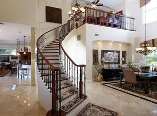 Designed and built by Creative Custom Stairs, this curved staircase was built in Port Charlotte, FL using black cherry treads and painted risers. The Old World black cherry handrail and Old World satin black balusters create remarkable lines. The elegant starting step is a double bullnose black cherry tread.