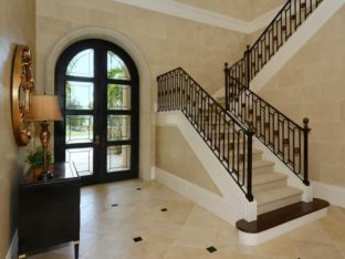 Located in Bradenton, this beautifully engineered u-shaped staircase has a Romanesque feel. With its large circular medallions amongst the oval shaped balusters. The bullnose stained starter tread creates a nice contrast to the light colored carpeted tread and risers.